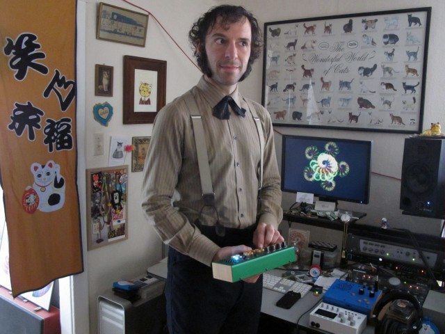 Daeelus In his home studio (holding a PocketPiano GR from Critter & Guitari)